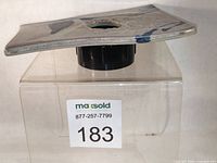 Side profile of vase showing curved slab form, central opening, glaze colors, and frog