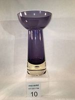 Full view of amethyst bubble vase standing on clear riser