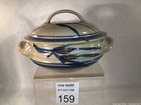 Front angled view showing full casserole dish with lid and handles