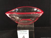 Side profile showing freeform shape and red rim