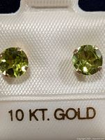 Front view showing round peridot stones in 10KT gold settings