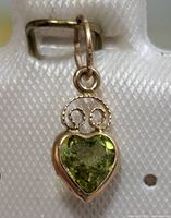 Front view of heart-shaped peridot pendant in 14K gold