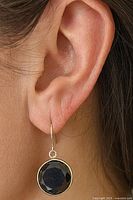Earring shown worn on ear displaying size and fit