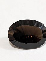 Top view of faceted oval smoky quartz gemstone