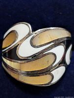 Front view of silver ring showing abstract wave design