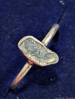 Top view of ring showing raw diamond stone and bezel