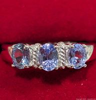 Front view of ring showing three tanzanite stones and silver detailing