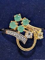 Top view of ring showing emerald cluster and clear stones