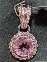 Front view showing round faceted pink quartz in silver bezel