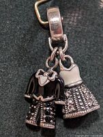 Full view of pendant showing both tuxedo and dress charms