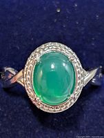front view showing oval green onyx cabochon and decorative silver bezel
