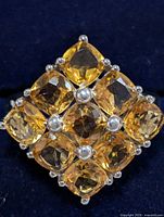 Front view showing nine cushion-cut citrines set in silver