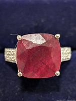 Front view showing cushion-cut dyed ruby and white topaz shoulders