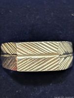 Front view showing engraved diagonal pattern on ring band