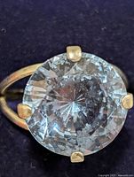 Top view showing large faceted gemstone in prong setting