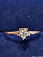 Ring top view showing flower setting and CZ stone