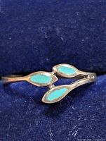 Front view showing three turquoise-colored marquise inlays on silver band