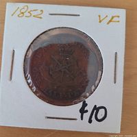 Obverse in coin flip showing horseman design and handwritten VF grading
