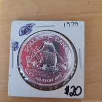 Reverse of 1979 Canadian silver dollar showing sailing ship design and holder markings