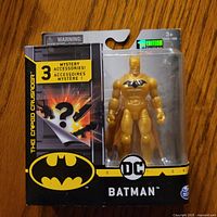 Front view of sealed gold Batman action figure package