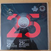 Front of sealed display card showing coin and 25th season graphics
