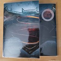 Front view of sealed blister pack showing coin and card set