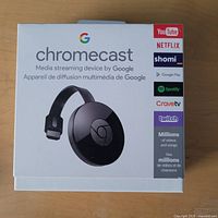 Front of retail box showing Chromecast branding and compatible services