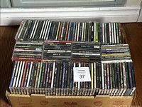 Box holding two layers of CDs, roughly 130 units visible