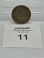 Front view showing reverse design, lot number card