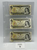 Front view of three 1973 Canadian $1 notes in sleeve