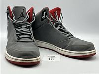 Three-quarter view of both sneakers showing uppers and laces