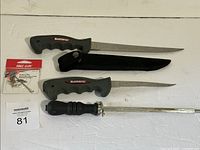 Overall lot showing two Shimano fillet knives, honing steel, Eagle Claw rig package