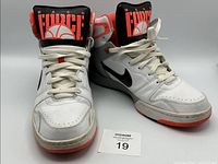 Oblique view of both shoes showing uppers, laces, and tongue graphics