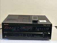 Front and top view of Pioneer VSX-D458 receiver with remote placed on top