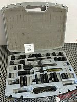 Open case view showing sockets, ratchet, extensions, driver and missing pieces