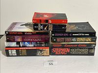 All nine books stacked showing spines and covers