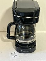 Front view showing full coffee maker with carafe