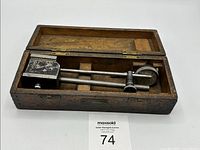 Open case displaying Mercer gauge with components