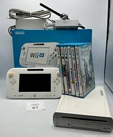Group shot showing console, GamePad, accessories, game stack, and retail box