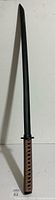 Full view of black wooden training sword
