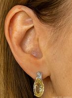 Earring worn on ear showing size and drop style