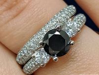 Top view of stacked rings showing black diamond and CZ stones