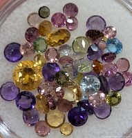 Top view of assorted coloured round cut gemstones