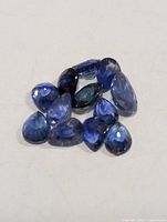 Group of loose blue sapphire gemstones on neutral background