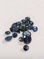 Front view of loose faceted blue sapphires on white background