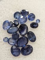 Loose blue sapphires spread to show variety of cuts and sizes