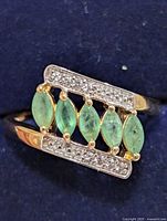 Top view showing emeralds and accent stones