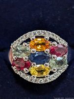 front view showing multicolored sapphires and halo