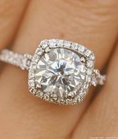 Front view of silver ring with large center stone and halo