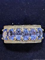 Front view showing five oval tanzanite stones with clear accent rows